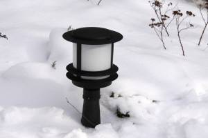 Низкий садово парковый светильник в снегу
